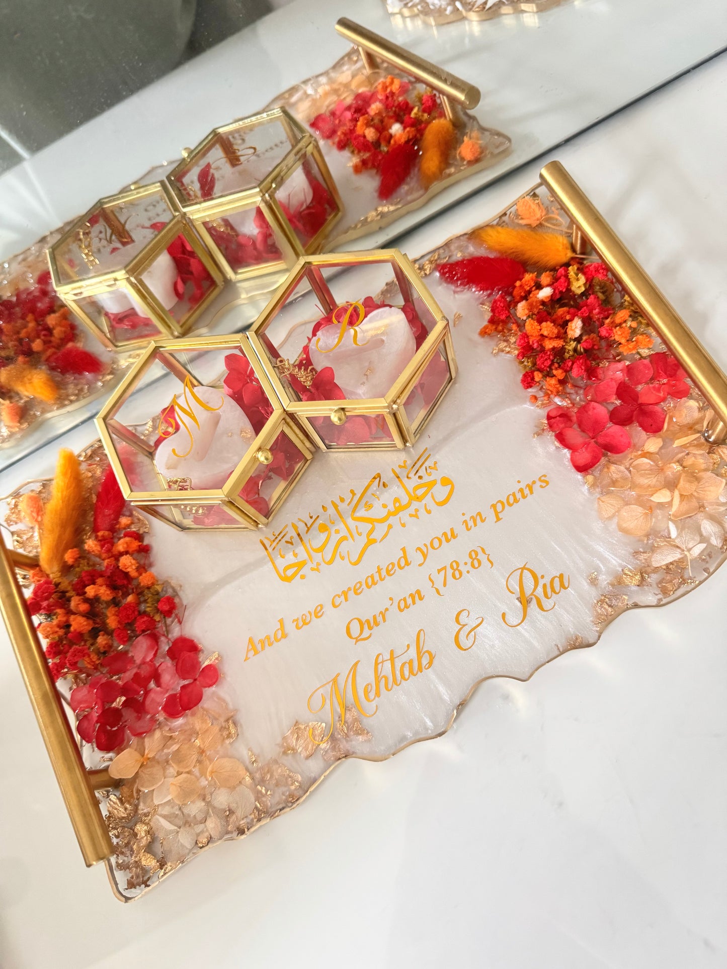 Dried red and orange flowers and gold rectangle tray