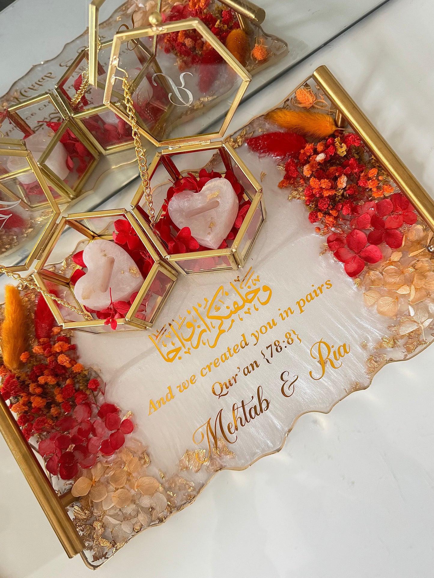 Dried red and orange flowers and gold rectangle tray